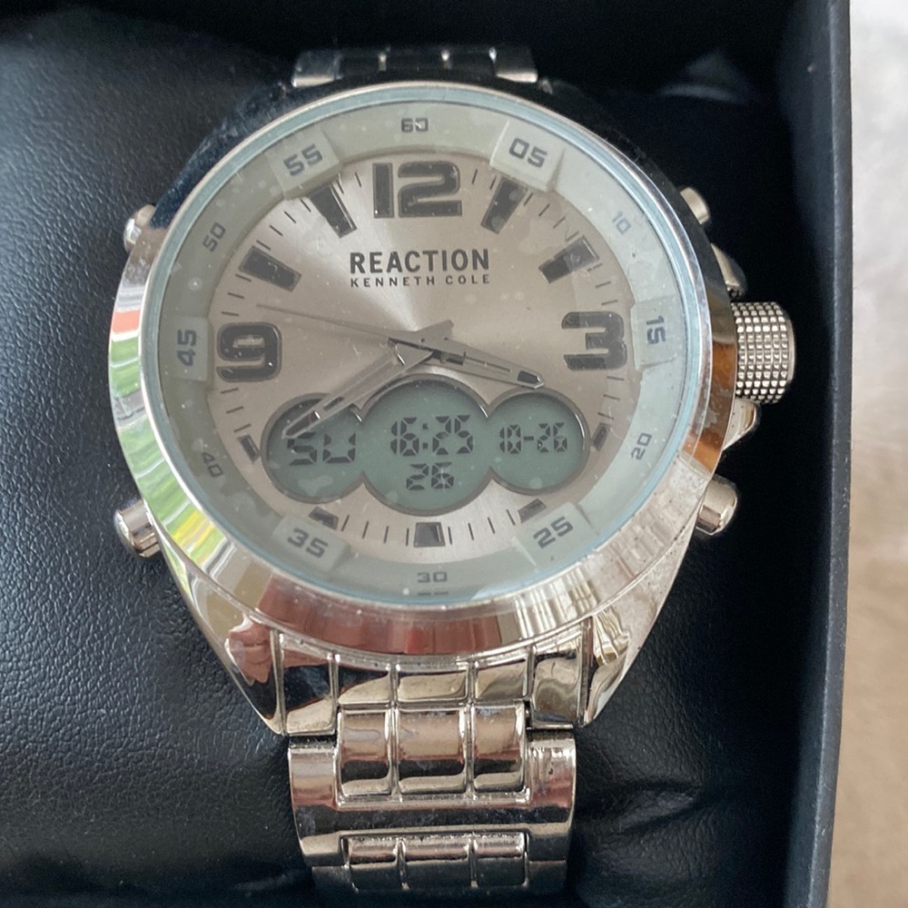 Men’s Kenneth Cole watch/stop watch with silver band Brand new in box.